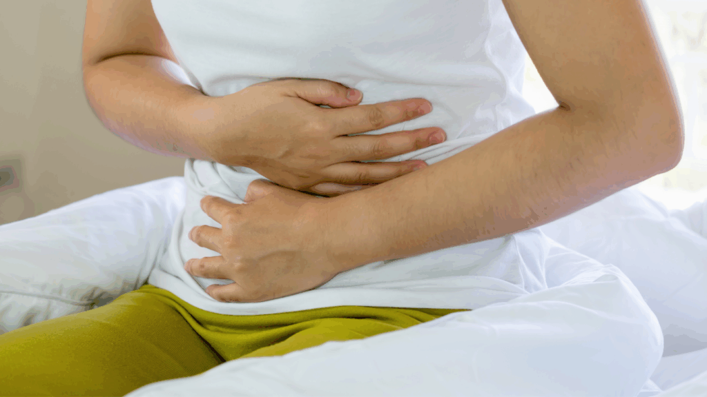 woman holding stomach experiencing runner’s gut