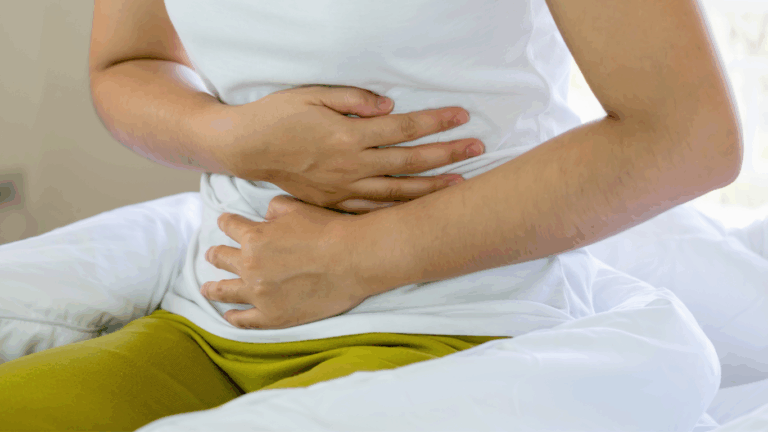 woman holding stomach experiencing runner’s gut